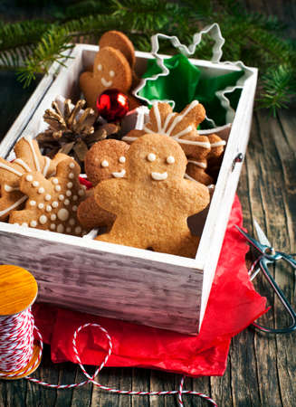Wooden box with Christmas gingerbread cookies and ornaments for giftの写真素材