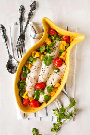 Baked fish fillet with tomatoes and sweet peppers