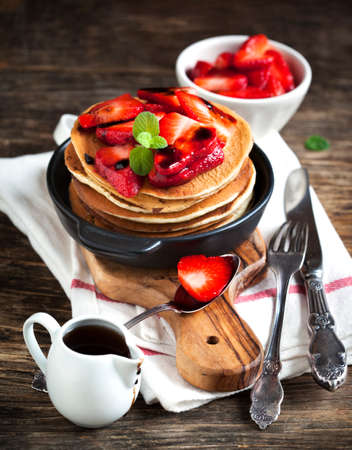 Stack of pancakes with fresh strawberry and balsamic glase in frying panの写真素材