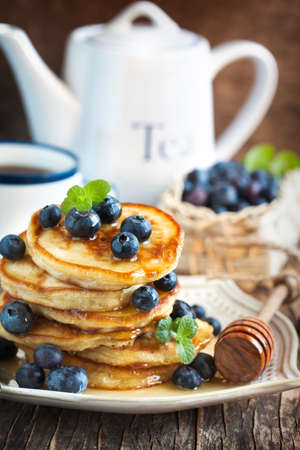 Stack of pancakes with fresh blueberry and honeyの写真素材