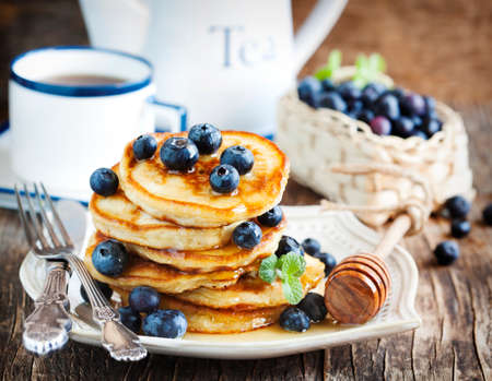 Stack of pancakes with fresh blueberry and honeyの写真素材