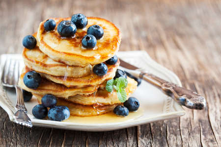 Stack of pancakes with fresh blueberry and honeyの写真素材