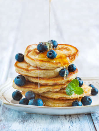 Stack of pancakes with fresh blueberry and honeyの写真素材