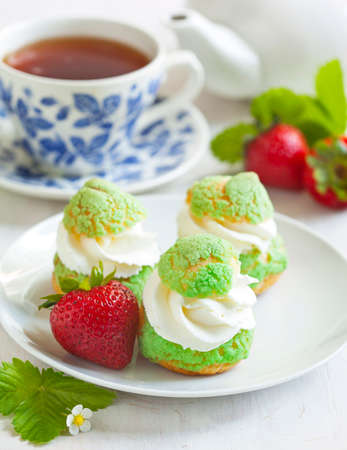 Profiteroles with strawberry compote and whipped cream.の写真素材