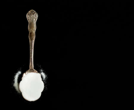 Vintage Silver Spoon of Sugar on Black Backgroundの写真素材