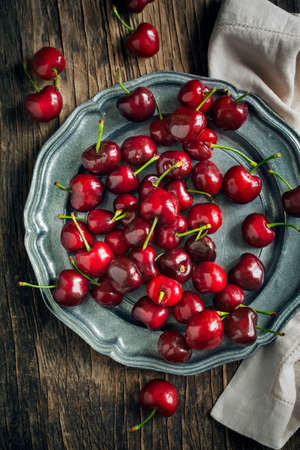 Sweet cherries on vintage plateの写真素材