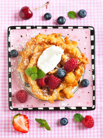 Funnel cakes with fresh berries and whipped creamの写真素材
