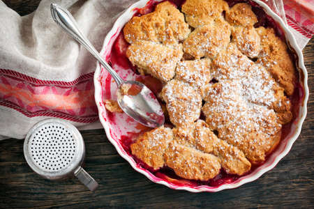 Stewed apple, plum and coconut cobbler.の写真素材
