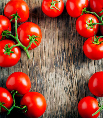 Fresh tomatoes on wooden backgroundの写真素材