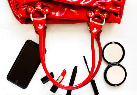 Women's set of fashion accessories on wooden background: shoes, handbag, cell phone and cosmeticsの写真素材