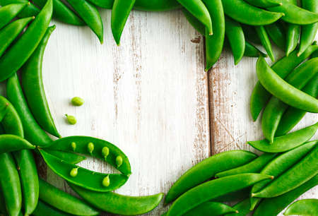 Green peas on wooden background with copy spaceの写真素材