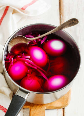 Homemade decoration eggs natural way. Naturally coloring Easter eggs with red cabbageの写真素材