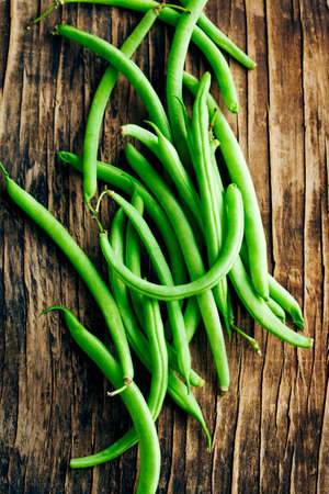 Fresh green beans on wooden backgroundの写真素材