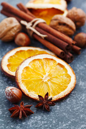Dry orange slices, cinnamon, anise and nutsの写真素材