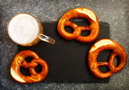 Pretzels and glass of beer, top viewの写真素材