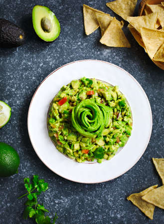 Guacamole and tortilla chips on stone backgroundの写真素材