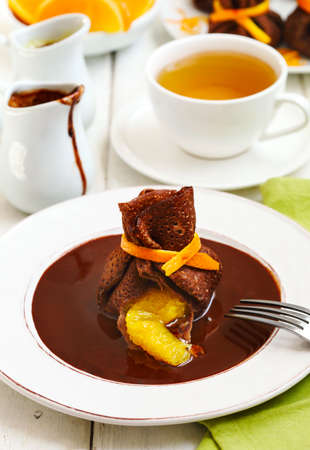 Chocolate pancakes with orange and chocolate sauceの写真素材