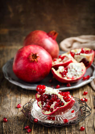 Fresh pomegranates on plateの写真素材