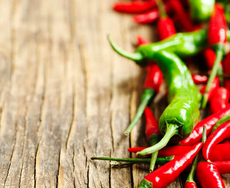 Hot peppers on wooden background with copy space
の写真素材