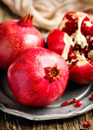 Fresh pomegranates on plateの写真素材