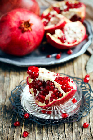 Fresh pomegranates on plateの写真素材