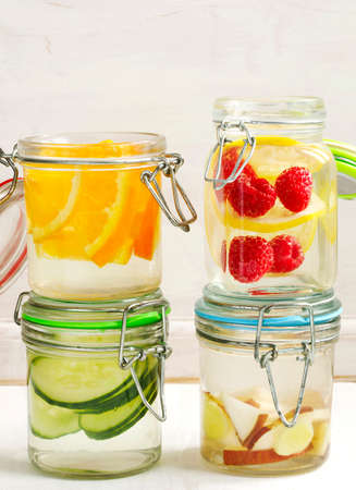 Healthy Spa Water with Fruit and vegetable. Cucumber spa water, pear and ginger spa water, lemon and raspberry spa water, and orange spa waterの写真素材