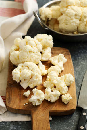 Fresh cauliflower on wooden cooking boardの写真素材