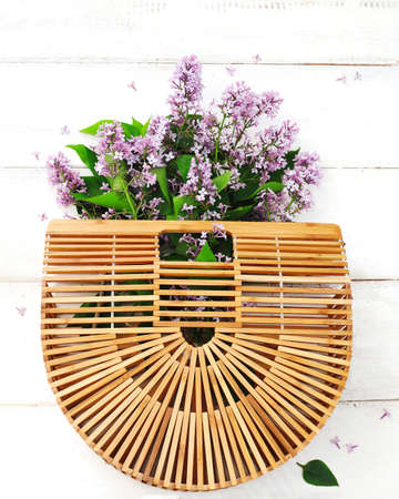 Bouquet of lilac in bamboo bagの写真素材
