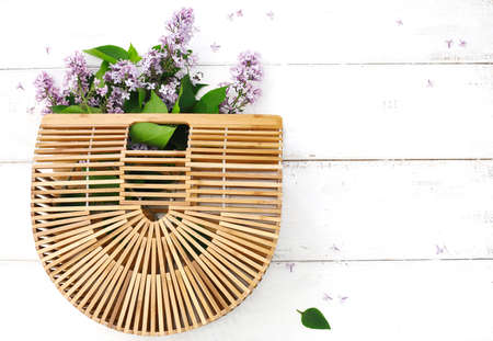 Bouquet of lilac in bamboo bagの写真素材