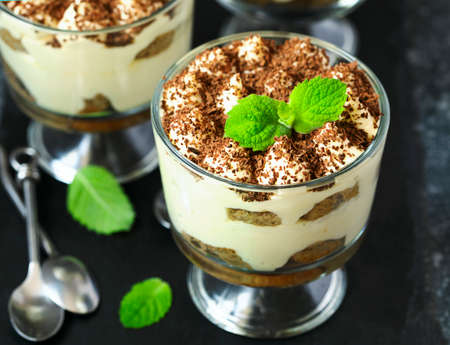 Homemade Italian dessert Tiramisu served in individual glassesの写真素材