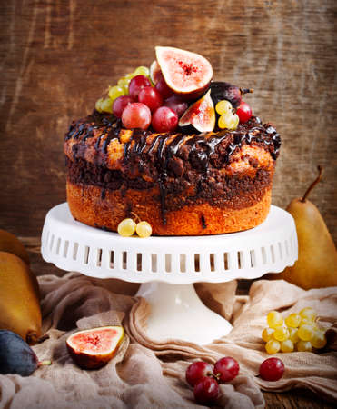 Chocolate coffee cake decorated with fresh fruitsの写真素材