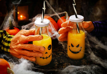 Orange cocktail in bottle for Halloween partiesの写真素材
