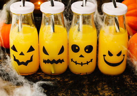 Orange cocktail in bottle for fall and halloween parties, toned imageの写真素材