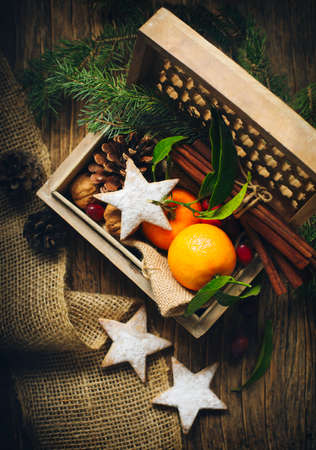 Christmas cookies and decoration in wooden box. Retro style dark colored picture.の写真素材