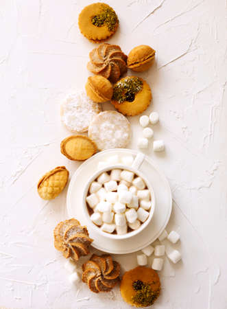 Cup of hot chocolate and assorted cookies: linzer cookies,shortbread, nuts cookie, orange almond cookie.の写真素材