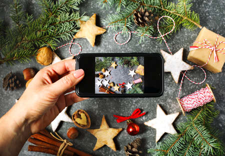 Female hands taking photo of Christmas decorationの写真素材