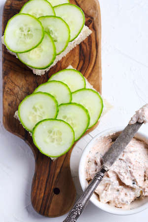 Sandwich with cucumber and smoked salmon cream, top viewの写真素材