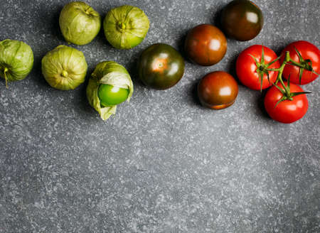 Various colorful tomatoes on stone background, top view, copy spaceの写真素材