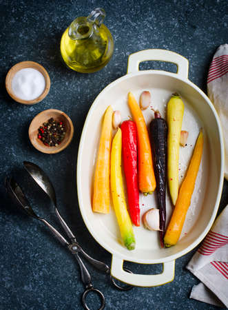 Fresh raw carrots on the baking dish ready for roasting. Top viewの写真素材
