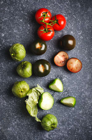 Various colorful tomatoes on stone background, top view.の写真素材