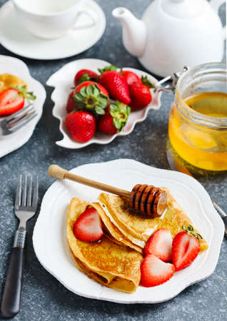 Crepes with berries and honeyの写真素材