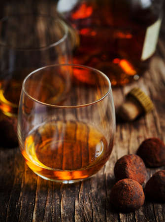 Glass of cognac and chocolate trufflesの写真素材