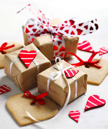 Gift boxes with decorative red hearts and heart shaped cookies. Festive background.の写真素材