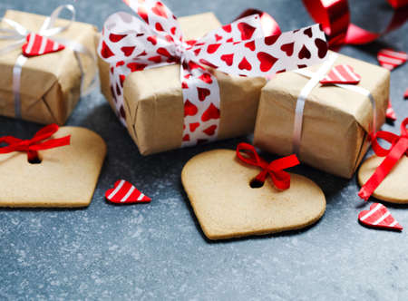 Gift boxes with decorative red hearts and heart shaped cookies. Festive background. Flatlay with copy space.の写真素材