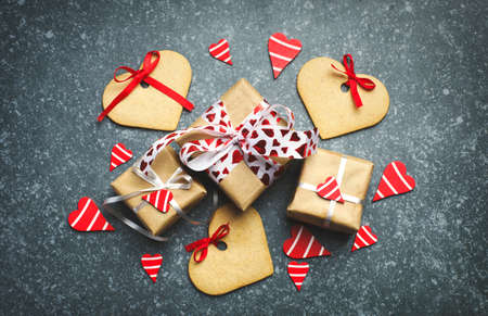 Gift box with decorative red hearts and heart shaped cookies. Festive background, top viewの写真素材