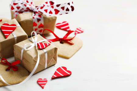 Gift boxes with decorative red hearts and heart shaped cookies. Festive background. の写真素材