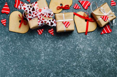 Gift boxes with decorative red hearts and heart shaped cookies. Festive background. Flatlay with copy space.の写真素材