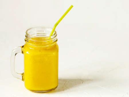 Banana Mango Smoothie in mason jar. Healthy vegan eating.の写真素材