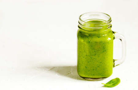 Green Spinach, Apple and Avocado Smoothie in mason jars. Healthy vegan eating.の写真素材
