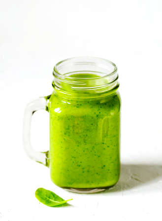 Green Spinach, Apple and Avocado Smoothie in mason jars. Healthy vegan eating.の写真素材